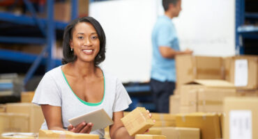IPC Team Workers In Warehouse Preparing Goods For Dispatch